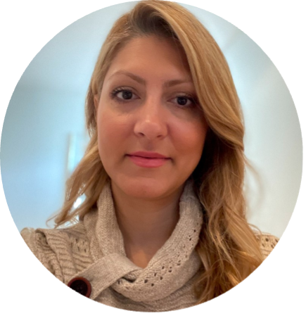 A head shot of Golnaz Ghaderi, with blond hair and brown yes, wearing a beige sweater.